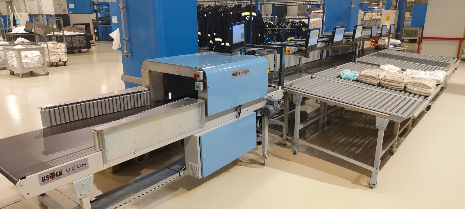 UCON RFID conveyor reader operating on a textile sorting line, with live screens visible along the conveyor